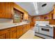 Cozy kitchen featuring wood paneling, classic appliances, and ample cabinet space at 1917 Bivins St, Durham, NC 27707
