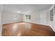 Spacious living room featuring hardwood floors, natural light, and a front entry door at 1917 Bivins St, Durham, NC 27707
