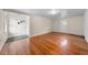 Spacious living room with hardwood floors, neutral walls and two entry doors at 1917 Bivins St, Durham, NC 27707