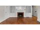 Spacious living room featuring hardwood floors, fireplace, and built in shelving at 1917 Bivins St, Durham, NC 27707