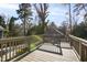 Wooden back deck surrounded by mature trees, providing an outdoor living space for relaxation and enjoyment at 2005 Glenwood Ave, Raleigh, NC 27608