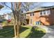 Brick home with a backyard deck, manicured lawn, and a paved driveway for easy access and additional parking at 2005 Glenwood Ave, Raleigh, NC 27608
