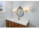 Modern bathroom boasts a decorative mirror, vanity, sink and light fixture at 2005 Glenwood Ave, Raleigh, NC 27608