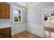 Bright breakfast nook features a decorative chandelier, hardwood floors, and a window view at 2005 Glenwood Ave, Raleigh, NC 27608