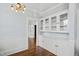 Dining room features hardwood floors, modern lighting, and built in glass front cabinets at 2005 Glenwood Ave, Raleigh, NC 27608