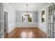 Inviting dining room with chandelier lighting, wainscoting, and hardwood floors for elegant dining at 2005 Glenwood Ave, Raleigh, NC 27608