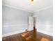 Empty room with light blue walls, hardwood floors, and classic trimwork at 2005 Glenwood Ave, Raleigh, NC 27608