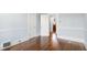 Empty room with hardwood floors, light blue walls, and classic trimwork at 2005 Glenwood Ave, Raleigh, NC 27608