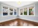 Bright empty room boasts natural light, hardwood floors, and multiple windows at 2005 Glenwood Ave, Raleigh, NC 27608