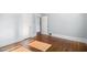 Empty room with hardwood floors, light blue walls, and doors to other rooms at 2005 Glenwood Ave, Raleigh, NC 27608