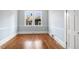 Sun-filled empty room boasts hardwood floors, light blue walls, and modern trimwork at 2005 Glenwood Ave, Raleigh, NC 27608