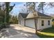 Spacious three-car garage with white doors, offering ample parking and storage space on the property at 2005 Glenwood Ave, Raleigh, NC 27608