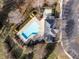Bird's-eye view of a community pool and parking area surrounded by mature landscaping at 206 May Farm Rd, Pittsboro, NC 27312