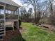 Exterior view of backyard showcasing a deck, green lawn, and a fire pit with seating at 206 May Farm Rd, Pittsboro, NC 27312