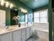 Bathroom featuring double sinks, soaking tub, shower, and elegant lighting at 206 May Farm Rd, Pittsboro, NC 27312