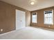 Bedroom with neutral carpet, closet and two windows for natural light at 206 May Farm Rd, Pittsboro, NC 27312