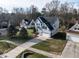Aerial view showcasing the house, driveway, and surrounding landscaping and neighborhood at 206 May Farm Rd, Pittsboro, NC 27312