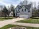 Traditional two-story home featuring a two-car garage, driveway, and lush green lawn at 206 May Farm Rd, Pittsboro, NC 27312