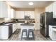 Bright eat-in kitchen with white cabinets, stainless steel appliances, and a center island at 206 May Farm Rd, Pittsboro, NC 27312