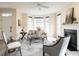 Cozy living room featuring neutral paint, a ceiling fan, and a fireplace with windows at 206 May Farm Rd, Pittsboro, NC 27312