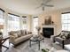 Cozy living room featuring neutral paint, a ceiling fan, and a fireplace with windows at 206 May Farm Rd, Pittsboro, NC 27312