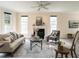 Inviting living room with neutral tones, ceiling fan, fireplace, and ample natural light at 206 May Farm Rd, Pittsboro, NC 27312