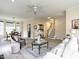Spacious living room featuring hardwood floors, staircase, and a large ceiling fan at 206 May Farm Rd, Pittsboro, NC 27312