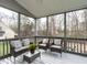 Cozy screened-in porch with comfortable seating and a view of the wooded backyard at 206 May Farm Rd, Pittsboro, NC 27312