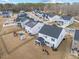 Aerial view showcasing backyard, screened-in porch, solar panels and neighborhood at 213 Chateau Way, Angier, NC 27501