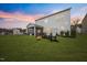 Spacious backyard featuring a fire pit, outdoor seating, and screened-in porch at 213 Chateau Way, Angier, NC 27501