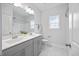 Bright bathroom features a double vanity, shower and white marble flooring at 213 Chateau Way, Angier, NC 27501