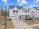 Beautiful white two story house features a charming porch, an attached garage and a well-manicured lawn at 213 Chateau Way, Angier, NC 27501