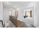 Upstairs hallway view of a well-lit sitting room with comfortable seating at 213 Chateau Way, Angier, NC 27501
