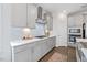 Bright kitchen features gray cabinets, stainless appliances, and lovely marble backsplash at 213 Chateau Way, Angier, NC 27501