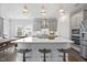 Modern kitchen with a large island, stainless steel appliances, and stylish bar stools for casual dining at 213 Chateau Way, Angier, NC 27501