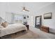 Spacious main bedroom featuring a tray ceiling, plush carpet, and a large window overlooking the outdoors at 213 Chateau Way, Angier, NC 27501
