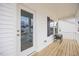Charming porch with wood flooring, decorative black shutters, and outdoor seating at 213 Chateau Way, Angier, NC 27501