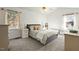 Bright bedroom with a large bed, a ceiling fan, two windows, and plush carpeting at 2204 Gentry Dr, Durham, NC 27705