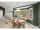 Inviting breakfast nook with natural light from bay windows with backyard views, adjacent to kitchen and stainless fridge at 2204 Gentry Dr, Durham, NC 27705