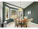 Charming breakfast nook features a wooden table, plush chairs, and a large bay window overlooking the backyard at 2204 Gentry Dr, Durham, NC 27705