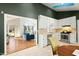 Bright kitchen boasts white cabinets and stainless steel appliances, seamlessly connecting to the living area at 2204 Gentry Dr, Durham, NC 27705