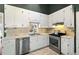 Well-lit kitchen featuring white cabinets, stainless steel appliances, and a convenient window above the sink at 2204 Gentry Dr, Durham, NC 27705