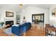 Bright living room featuring a fireplace, hardwood floors, and a dining area with large windows at 2204 Gentry Dr, Durham, NC 27705