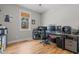 Office space with hardwood flooring, a window with blinds, and a modern desk setup at 2690 Meadow View Ln, Sanford, NC 27332