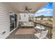 Covered back porch features a ceiling fan, seating, railings, and access to the home's interior at 274 Roaring Creek Dr, Garner, NC 27529