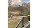 A view of the backyard from a wooden deck, revealing a small ravine and bordering treeline at 274 Roaring Creek Dr, Garner, NC 27529