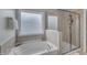 Relaxing bathroom with a soaking tub, separate shower, and frosted glass window at 274 Roaring Creek Dr, Garner, NC 27529