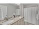 Bathroom features a double sink vanity with granite countertops and a shower with a curtain at 274 Roaring Creek Dr, Garner, NC 27529