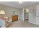 Bright Bedroom with beige carpet, dresser, mirror, and an adjacent doorway at 274 Roaring Creek Dr, Garner, NC 27529