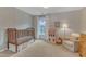 Charming Bedroom with wood crib, window, and cozy decor for a comforting ambiance at 274 Roaring Creek Dr, Garner, NC 27529